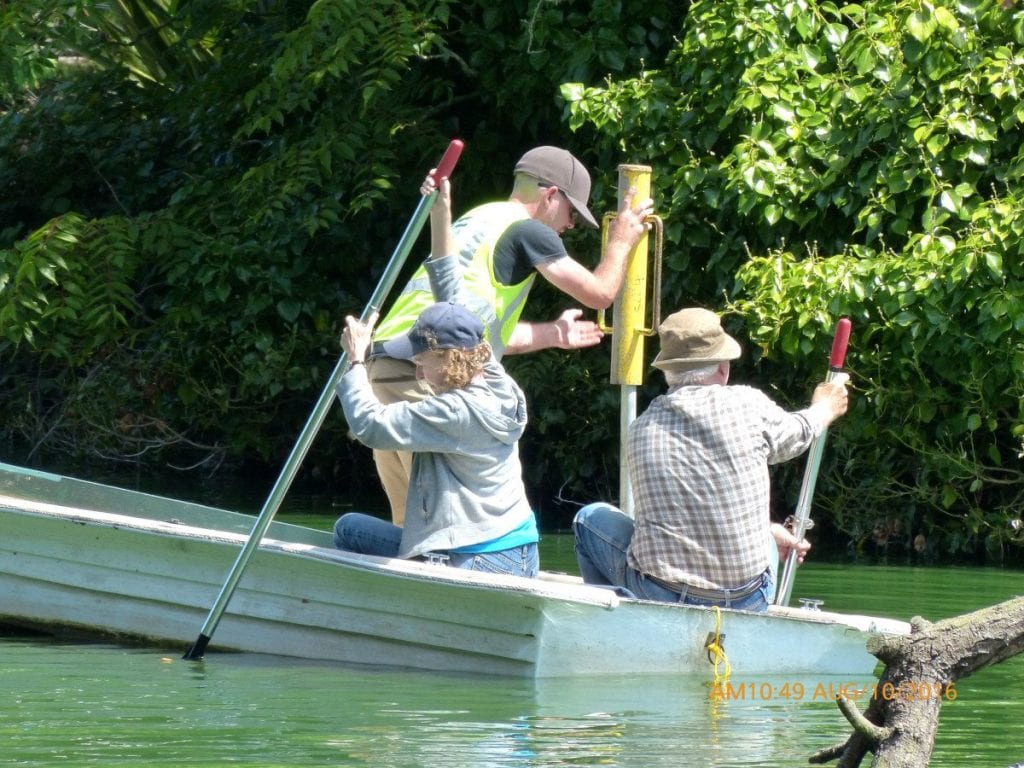 Noreen holds the boat steady while Dan installs the pole. Photo by Lee Karney
