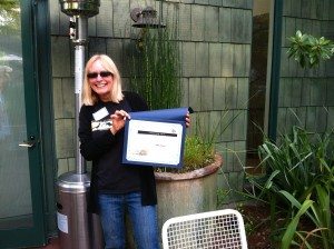 Denise Wight shows off her Paul Covel award for environmental education. Photo by Ilana DeBare.