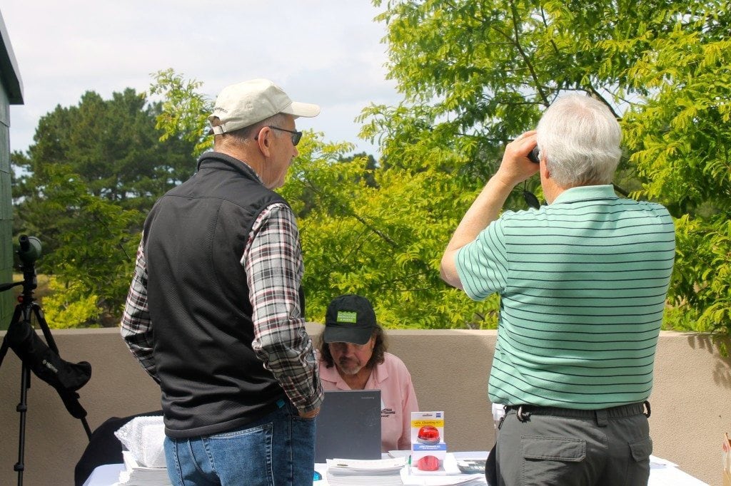 Gary Bard and Dan Harris try out optics from Woodland Hills Camera & Optics at the Birdathon Celebration 