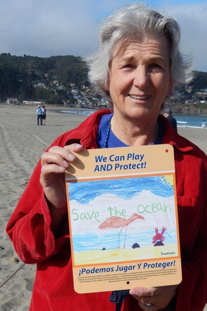 Pacifica City Councilperson Sue Digre, a staunch and early supporter of plover protection, holds one of the student-designed signs / Photo by Sue Morgan